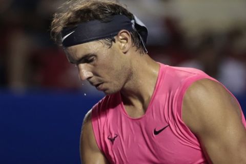 Sweat drips from the nose of Spain's Rafael Nadal as he prepares to serve to Bulgaria's Grigor Dimitrov in the semifinals of the Mexican Open tennis tournament in Acapulco, Mexico, Friday, Feb. 28, 2020. (AP Photo/Rebecca Blackwell)