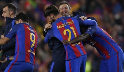 Barcelona's head coach Luis Enrique celebrates with some of his players at the end of the Champions League round of 16, second leg soccer match between FC Barcelona and Paris Saint Germain at the Camp Nou stadium in Barcelona, Spain, Wednesday March 8, 2017. Barcelona won the match 6-1 (6-5 on aggregate). (AP Photo/Manu Fernandez)