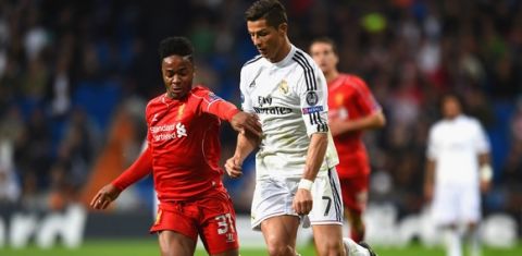 MADRID, SPAIN - NOVEMBER 04:  Raheem Sterling of Liverpool and Cristiano Ronaldo of Real Madrid CF battle for the ball during the UEFA Champions League Group B match between Real Madrid CF and Liverpool FC at Estadio Santiago Bernabeu on November 4, 2014 in Madrid, Spain.  (Photo by Shaun Botterill/Getty Images)