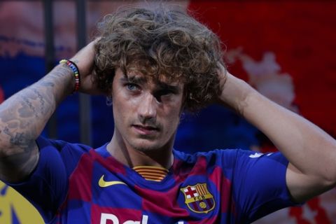 French forward Antoine Griezmann poses for the media during his official presentation after signing for FC Barcelona in Barcelona, Spain, Sunday, July 14, 2019. (AP Photo/Emilio Morenatti)