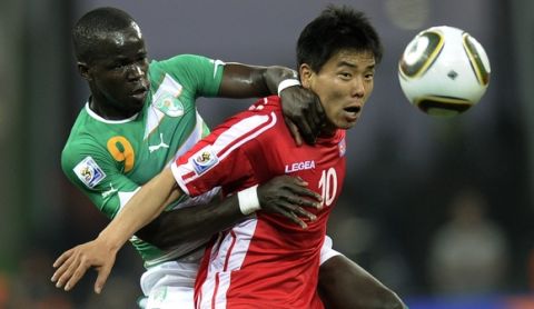 North Korea's Hong Yong Jo, right, vies for the ball with Ivory Coast's Cheick Tiote during the World Cup group G soccer match between North Korea and Ivory Coast at Mbombela Stadium in Nelspruit, South Africa, Friday, June 25, 2010.  (AP Photo/Martin Meissner)