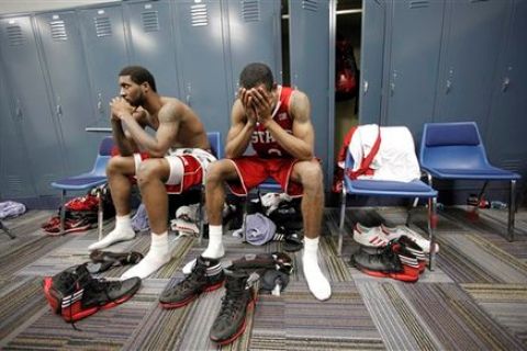 North Carolina State forward Richard Howell, left, and North Carolina State guard Lorenzo Brown reacts in the locker room after an NCAA tournament Midwest Regional college basketball game Saturday, March 24, 2012, in St. Louis. Kansas won 60-57. (AP Photo/Charlie Riedel)
