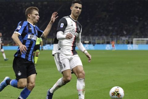 Inter Milan's Nicolo Barella, left, fights for the ball with Juventus' Cristiano Ronaldo during a Serie A soccer match between Inter Milan and Juventus, at the San Siro stadium in Milan, Italy, Sunday, Oct. 6, 2019. (AP Photo/Luca Bruno)