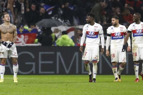 Lyon's Memphis Depay, left, celebrates after scoring his side's second goal during the French League One soccer match between Lyon and Paris Saint Germain in Decines, near Lyon, central France, Sunday, Jan. 21, 2018. (AP Photo/Laurent Cipriani)
