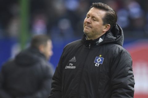Hamburg coach  Christian Titz reacts after a missed chance for is team during the German Bundesliga soccer match between Hamburger SV and Hertha BSC Berlin, in Hamburg, Germany, Saturday, March 17, 2018. (Daniel Reinhardt/dpa via AP)