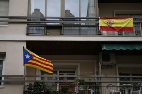 A Spanish flag, right, and an ''estelada'' or Catalonia independence flag hang on balconies of a building in Barcelona Saturday, Sept. 30 2017. Catalonia's planned referendum on secession is due to be held Sunday by the pro-independence Catalan government but Spain's government calls the vote illegal, since it violates the constitution, and the country's Constitutional Court has ordered it suspended. (AP Photo/Bob Edme)