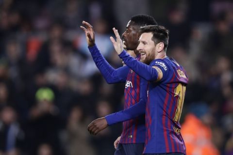 FC Barcelona's Dembele, left, celebrates with his teammate Lionel Messi after scoring his side's second goal during a Spanish Copa del Rey soccer match between FC Barcelona and Levante at the Camp Nou stadium in Barcelona, Spain, Thursday, Jan. 17, 2019. (AP Photo/Manu Fernandez)