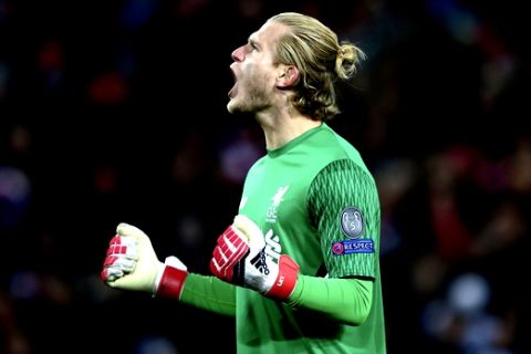 Liverpool goalkeeper Loris Karius celebrates after his team scored their first goal during the Champions League quarter final first leg soccer match between Liverpool and Manchester City at Anfield stadium in Liverpool, England, Wednesday, April 4, 2018. (AP Photo/Dave Thompson)
