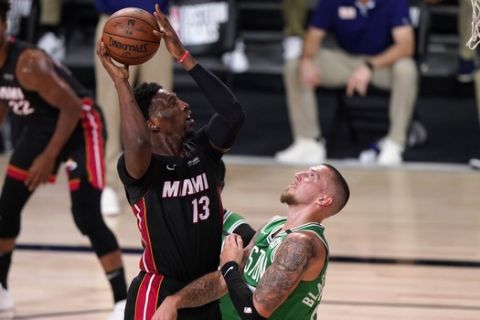 Miami Heat forward Bam Adebayo (13) attempts a shot over Boston Celtics' Daniel Theis, right, during the first half of Game 4 of an NBA basketball Eastern Conference final, Wednesday, Sept. 23, 2020, in Lake Buena Vista, Fla. (AP Photo/Mark J. Terrill)