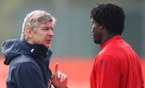 Arsenal's Emmanuel Adebayor, right, talks to manager Arsene Wenger, during their training session, London Colney, England, Tuesday April 14, 2009. Arsenal will face Villarreal in a Champions League, quarterfinal 2nd leg soccer match, at the Emirates Stadium, Wednesday. (AP Photo/Tom Hevezi)