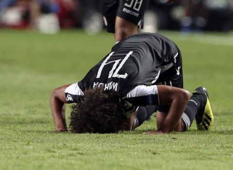 PAOK's Amr Warda, bottom, celebrates scoring his side's first goal during the Champions League playoffs, first leg, soccer match between Benfica and PAOK at the Luz stadium in Lisbon, Tuesday, Aug. 21, 2018. (AP Photo/Armando Franca)