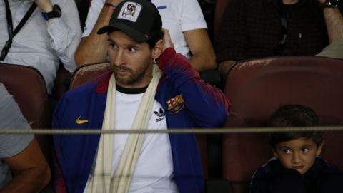 Barcelona forward Lionel Messi sits in the stands prior to the Champions League, Group B soccer match between Barcelona and Inter Milan, at the Nou Camp in Barcelona, Spain, Wednesday, Oct. 24, 2018. (AP Photo/Emilio Morenatti)
