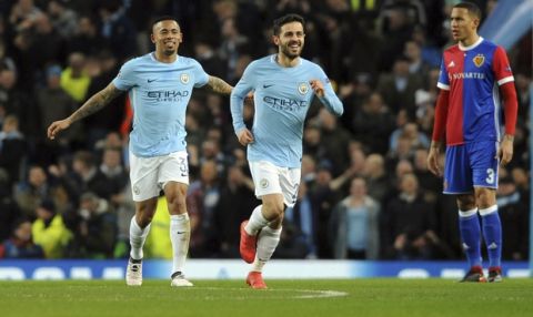 Manchester City's Gabriel Jesus, left, celebrates after scoring his side's opening goal during the Champions League, round of 16, second leg soccer match between Manchester City and Basel at the Etihad Stadium in Manchester, England, Wednesday, March 7, 2018. (AP Photo/Rui Vieira)