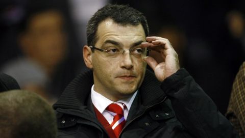 Liverpool's new director of football strategy Damien Comolli takes his seat before the team's Europa League soccer match against Napoli at Anfield Stadium, Liverpool, England, Thursday Nov. 4, 2010. (AP Photo/Tim Hales)