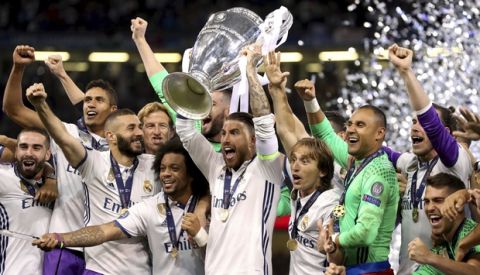Real Madrid's captain Sergio Ramos raises the trophy after the Champions League Final soccer match between Juventus and Real Madrid at the Millennium Stadium in Cardiff, Wales, Saturday, June 3, 2017. (Nick Potts/PA via AP)