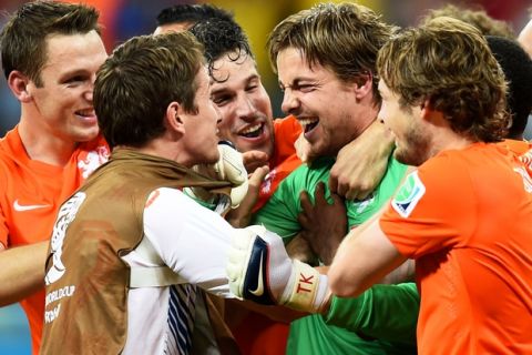 SALVADOR, BRAZIL - JULY 05: Goalkeeper Tim Krul of the Netherlands celebrates with teammates after making a save in a penalty shootout to defeat Costa Rica during the 2014 FIFA World Cup Brazil Quarter Final match between the Netherlands and Costa Rica at Arena Fonte Nova on July 5, 2014 in Salvador, Brazil.  (Photo by Jamie McDonald/Getty Images)