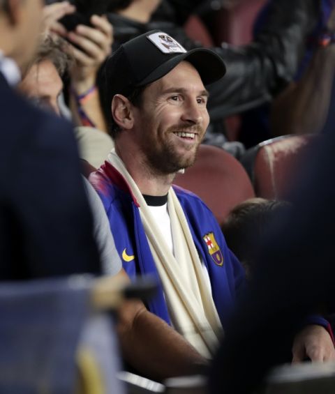 Barcelona forward Lionel Messi sits in the stands prior to the Champions League, Group B soccer match between Barcelona and Inter Milan, at the Nou Camp in Barcelona, Spain, Wednesday, Oct. 24, 2018. (AP Photo/Manu Fernandez)