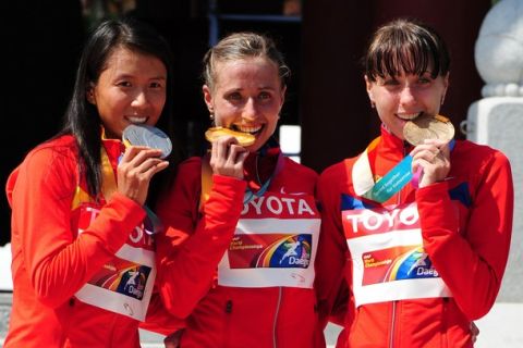 China's Hong Liu (L), Russia's Olga Kaniskina (C) and Russia's Anisya Kirdyapkina pose with their medals during the medal ceremony after the Women's 20km walk at the International Association of Athletics Federations (IAAF) World Championships in Daegu on August 31, 2011. Kaninskana took gold with Liu in silver and Kirdyapkina in bronze.
AFP PHOTO / MARK RALSTON (Photo credit should read MARK RALSTON/AFP/Getty Images)