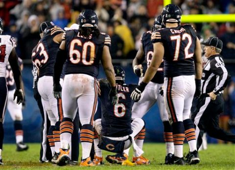 Chicago Bears quarterback Jay Cutler (6) is helped up by teammates after he threw an illegal forward pass and was hit by Houston Texans linebacker Tim Dobbins during the first half of an NFL football game, Sunday, Nov. 11, 2012, in Chicago. Dobbins was penalized for unnecessary roughness on the play. Cutler did not return in the second half after suffering a concussion. (AP Photo/Nam Y. Huh)