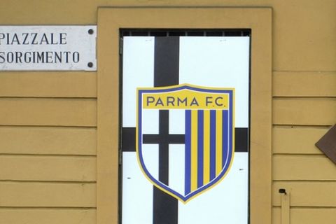 In this March 8, 2015 file photo a man stands outside the Tardini stadium as a note behind him reads in Italian "Chiuso per rapina" (Closed after robbery) prior to a Serie A soccer match between Parma and Atalanta in Parma, Italy. An Italian court Thursday, March 19, 2015 has declared crisis-hit Serie A club Parma bankrupt with estimated debts of nearly 100 million euros ($110 million). It is not known whether Parma will be able to finish the season. There is a plan in place with the league's governing body and the Italian football federation to fund the club for the rest of the campaign. (AP Photo/Marco Vasini, File)