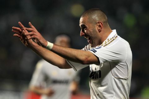 Real Madrid's French forward Karim Benzema celebrates after scoring his second goal of the game during their UEFA Champions League first leg quarter-final football match aginst APOEL at the GSP Stadium in Nicosia on March 27, 2012. Real Madrid won the match 3-0. AFP PHOTO / PATRICK BAZ (Photo credit should read PATRICK BAZ/AFP/Getty Images)
