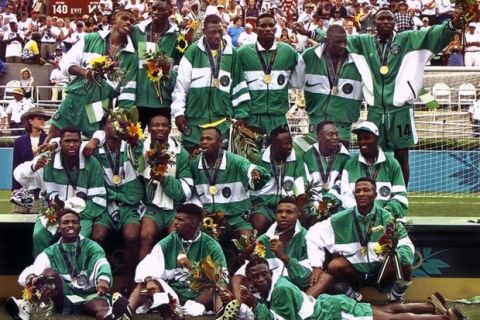 A picture taken in Athens, Georgia on August 3, 1996 shows Nigeria's Olympic soccer team posing for photographers after receiving their gold medals during the 1996 Summer Olympic final match. Nigeria beat Argentina 3-2 to take the gold. AFP PHOTO PASCAL GEORGE (Photo credit should read PASCAL GEORGE/AFP/Getty Images)