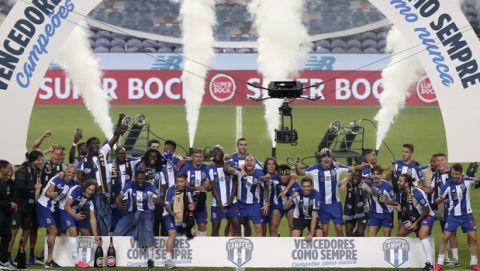 Porto players celebrate on the pitch at the end of the Portuguese League soccer match between FC Porto and Sporting CP at the Dragao stadium in Porto, Portugal, Wednesday, July 15, 2020. Porto defeated Sporting 2-0 to clinch the championship with two rounds left to play. (AP Photo/Luis Vieira)
