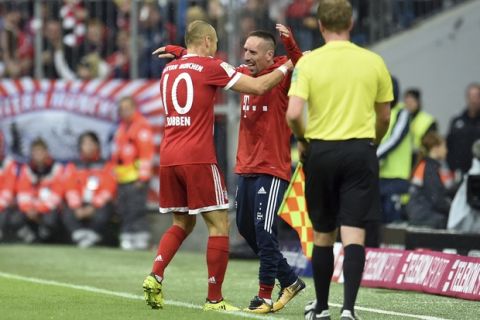 Munich's Arjen Robben, left, celebrates his second goal with Franck Ribery who sits on the bench during the first division Bundesliga soccer match between Bayern Munich and FSV Mainz 05 in Munich, Germany, Saturday, Sept. 16, 2017. (Andreas Gebert/dpa via AP)