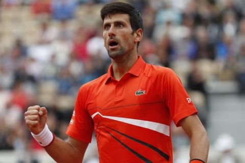 Serbia's Novak Djokovic clenches his fist after scoring a point against Switzerland's Henri Laaksonen during their second round match of the French Open tennis tournament at the Roland Garros stadium in Paris, Thursday, May 30, 2019. (AP Photo/Jean-Francois Badias)