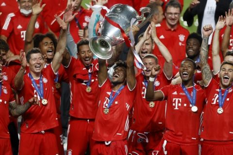 Bayern's Kingsley Coman lifts the trophy after Munich won the Champions League final soccer match between Paris Saint-Germain and Bayern Munich at the Luz stadium in Lisbon, Portugal, Sunday, Aug. 23, 2020.(Matthew Childs/Pool via AP)