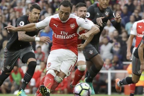 FILE - In this file photo dated Saturday, Sept. 10, 2016, Arsenal's Santi Cazorla scores against Southampton during the English Premier League soccer match at Emirates stadium in London.  In an interview published Friday Nov. 3, 2017, in Spanish newspaper Marca, 32-year old Spanish midfielder Santi Cazorla says he is looking to resume his playing career at Arsenal after being told by doctors he might be unable to walk again amid a succession of injuries. (AP Photo/Kirsty Wigglesworth, FILE)