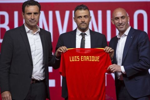 Spanish coach Luis Enrique, centre, Spanish football President Luis Rubiales, right, and Spanish football sports director Jose Francisco Molina pose for the media during the official presentation of Luis Enrique as Spain new head coach in Las Rozas, on the outskirts of Madrid, Thursday, July 19, 2018. (AP Photo/Francisco Seco)