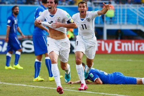 NATAL, BRAZIL - JUNE 24:  Diego Godin of Uruguay celebrates scoring his team's first goal during the 2014 FIFA World Cup Brazil Group D match between Italy and Uruguay at Estadio das Dunas on June 24, 2014 in Natal, Brazil.  (Photo by Clive Rose/Getty Images)