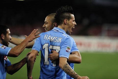 SSC Napoli's Marek Hamsik (R) and teammates Gokan Inler (C) and Walter Gargano (R) celebrate after scoring during the Italian serie A football match between SSC Napoli and Cagliari Calcio at the San Paolo Stadium on March 9, 2012 in Naples.  AFP PHOTO / ROBERTO SALOMONE (Photo credit should read ROBERTO SALOMONE/AFP/Getty Images)