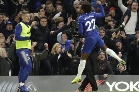 Chelsea's Willian, right, celebrates his side's second goal during the English Premier League soccer match between Chelsea and Newcastle United at Stamford Bridge stadium in London, Saturday, Jan. 12, 2019. (AP Photo/Matt Dunham)