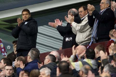 Aston Villa's Stiliyan Petrov, left, who has been diagnosed with Leukemia stands up in the stands to applause from the crowd ahead of the English Premier League soccer match between Chelsea and Aston Villa at Villa Park Stadium in Birmingham, Saturday, March 31, 2012. (AP Photo/Kirsty Wigglesworth) 