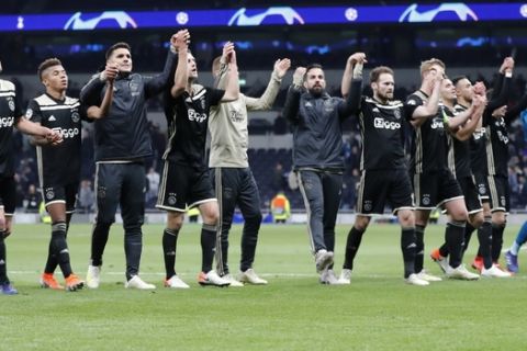 Ajax players celebrate their 1-0 win after the Champions League semifinal first leg soccer match between Tottenham Hotspur and Ajax at the Tottenham Hotspur stadium in London, Tuesday, April 30, 2019. (AP Photo/Frank Augstein)