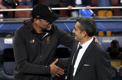 Liverpool coach Juergen Klopp, left, and Barcelona coach Ernesto Valverde greet each other before the Champions League semifinal, first leg, soccer match between FC Barcelona and Liverpool at the Camp Nou stadium in Barcelona Spain, Wednesday, May 1, 2019. (AP Photo/Joan Monfort)
