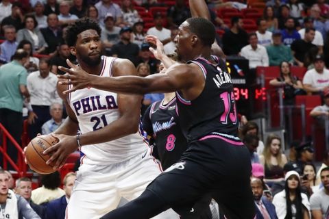 Philadelphia 76ers center Joel Embiid looks to pass the ball against Miami Heat center Bam Adebayo in the first quarter of an NBA basketball game Monday, Nov. 12, 2018, in Miami. (AP Photo/Brynn Anderson)