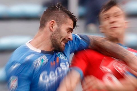 Napoli's Vlad Chiriches, right, jumps for the ball with Empoli's Marko Livaja during an Italian Serie A soccer match between Empoli and Napoli in Empoli, Italy, Sunday, Sept. 13, 2015. (AP Photo/Paolo Lazzeroni)