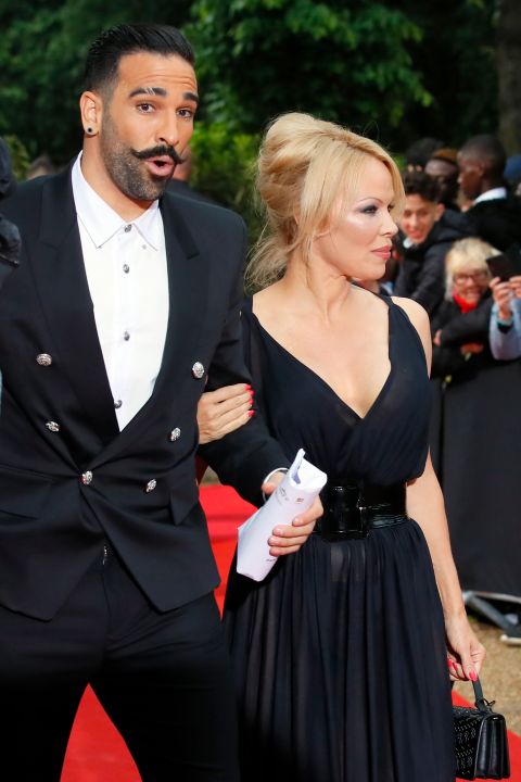 Soccer player Adil Rami and US actress Pamela Anderson arrive at the UNFP (Union of French Professional Footballers) ceremony, in Paris, France, Sunday, May 19, 2019. (AP Photo/Francois Mori)