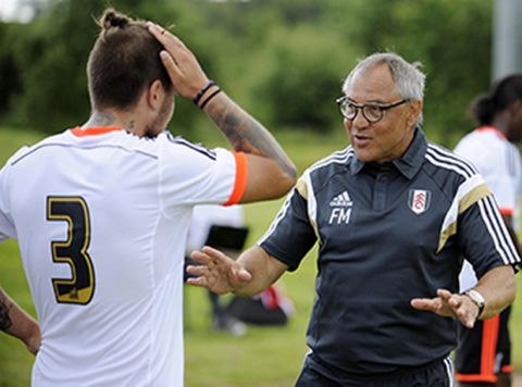 Fulham Manager Felix Magath and Kostas Stafylidis (left) chat
