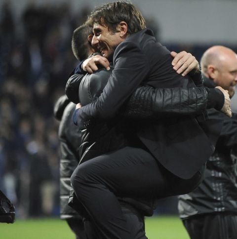 Chelsea's manager Antonio Conte gets a hug after the English Premier League soccer match between West Bromwich Albion and Chelsea, at the Hawthorns in West Bromwich, England, Friday, May 12, 2017. Chelsea won the match 0-1 meaning they win the Premiership title. (AP Photo/Rui Vieira)