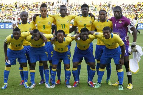 Gabon soccer players, from left at back, Cedric Moubamba, Pierre Eymerick Aubameyang, Eric Mouloungui, Bruno Manga Ecuele, Stephane N'Guema, and from left at front, Levy Madinda, Andre Poko Biyogo, Charly Moussono, Edmond Mouele, Charly Moussono, Remy Ebanega pose for a team photo prior to their African Cup of Nations Group C soccer match against Niger at Stade De L'Amitie in Libreville, Gabon, in this Jan. 23, 2012 file photo. (AP Photo/Francois Mori)
