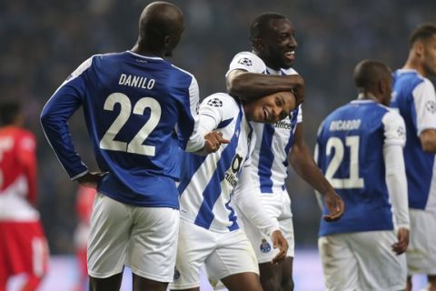 Porto's Yacine Brahimi, center, celebrates with Danilo, left, and Moussa Marega after scoring his side's third goal during the Champions League group G soccer match between FC Porto and AS Monaco at the Dragao stadium in Porto, Portugal, Wednesday, Dec. 6, 2017. (AP Photo/Luis Vieira)
