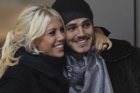 Inter Milan forward Mauro Icardi, of Argentina, poses with Argentine model Wanda Nara as they sit in the stands prior to a Serie A soccer match between Inter Milan and Chievo, at the San Siro stadium in Milan, Italy, Monday, Jan.13, 2014. (AP Photo/Luca Bruno)