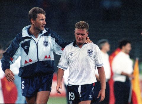 England's Paul Gascoigne cries as he is escorted off the field by team captain Terry Butcher, after his England lost a penalty shoot-out in the semi-final match of the World Cup against West Germany, July 4, 1990, in Turin, Italy. (AP Photo/Roberto Pfeil)