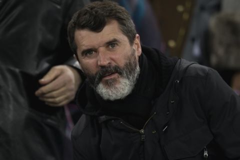 Roy Keane, assistant manager of the Republic of Ireland national football team, takes his seat before the English Premier League soccer match between Everton and Queens Park Rangers at Goodison Park Stadium, Liverpool, England, Monday Dec. 15, 2014. (AP Photo/Jon Super)