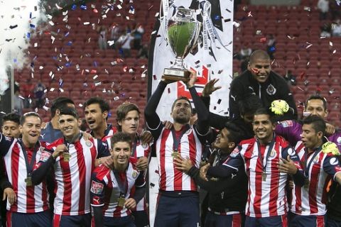 The players of Mexico's Chivas celebrate with the trophy after defeating Argentina's Boca Juniors, during a friendly soccer match in Guadalajara, Mexico, Thursday, Feb. 2, 2017. (AP Photo/Bruno Gonzalez)