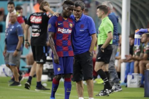 Barcelona head coach Ernesto Valverde, right, talks with Moussa Wague, left, during the first half of a LaLiga-Serie A Cup soccer match against Napoli, Wednesday, Aug. 7, 2019, in Miami Gardens, Fla. (AP Photo/Lynne Sladky)